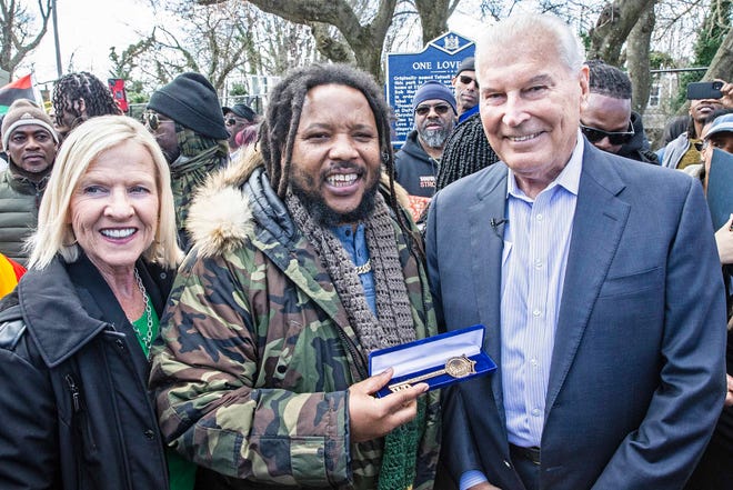 Stephen Marley, son of Bob and Rita Marley, flanked by Lieutenant Governor of Delaware Bethany Hall-Long and Mayor Purzycki, holds the key to the city presented to him by Mayor Purzycki at One Love Park/Tatnall Street Park in Wilmington, Wednesday, March 20, 2024. Marley, who was born in Wilmington and lived at the family's home on 24th Street.