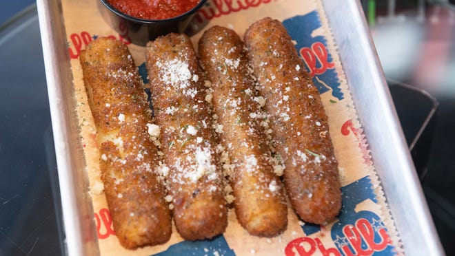 Big Mozz sticks are displayed during an event to highlight what is new for the 2024 Philadelphia Phillies season at Citizens Bank Park in Philadelphia on Monday, March 25, 2024.