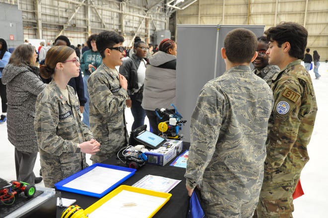From left, Delaware Civil Air Patrol cadets Abigail Cranford and Sebastian Somoano talk to students about robotics during Delaware’s inaugural Tuskegee Airmen Commemoration Day Expo at Dover Air Force Base March 28.