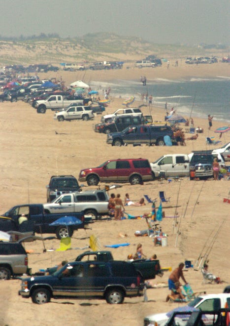 Surf fishermen line the beach with their vehicles at Delaware Seashore State Park on Saturday, July 14, 2007.