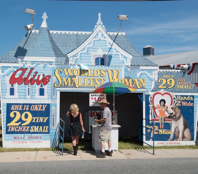 A couple checks out the World's Smallest Woman at the 99th annual Delaware State Fair in Harrington.