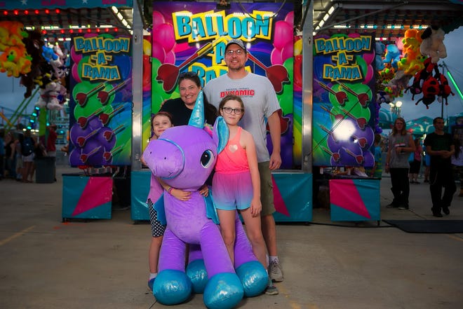 Martin and Lisa Hoeber and their daughters Layna, 10, and Scarlett, 8, enjoy the Delaware State Fair Monday night.
