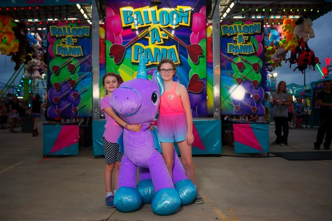 Layna Hoeber (right), 10, and Scarlett, 8, enjoy the Delaware State Fair Monday night.
