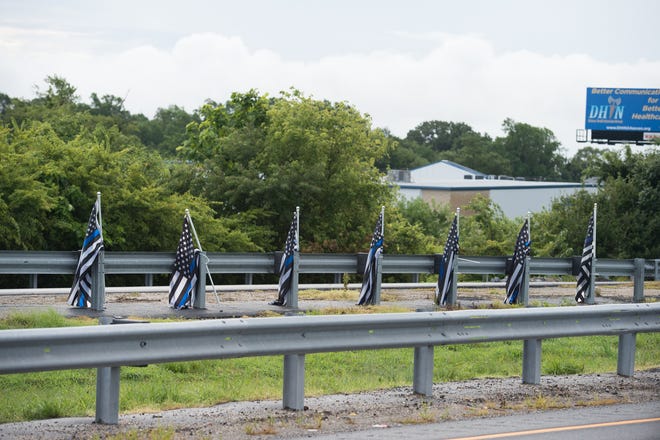 View of thin blue line flags along Del 1 near Lewes, a symbol that supports law enforcement.