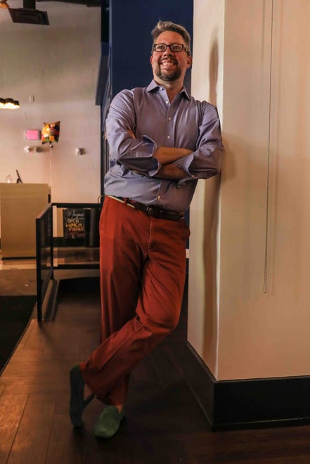 Gavin Bish pose wears a lavender dress shirt by Van Heusen, red chinos by Ralph Lauren and green suede driver's loafers by New Republic.