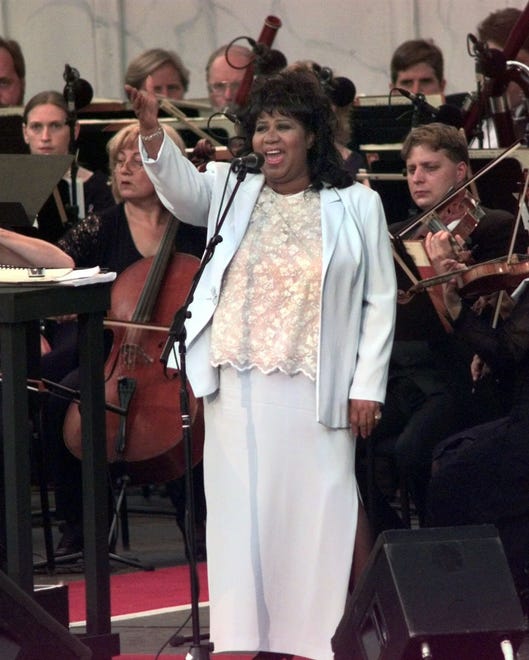 Aretha Franklin sings the national anthem at the beginning of "The Three Tenors" concert at Tiger Stadium in Detroit, Saturday, July 17, 1999.