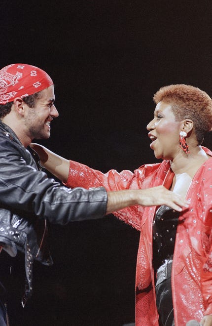 Singing great Aretha Franklin joins George Michael on stage during his Faith World Tour in the Detroit area at the Palace of Auburn Hills, Aug. 30, 1988. The duo sang their Grammy-winning hit "I Knew You Were Waiting." (AP Photo/Rob Kozloff)