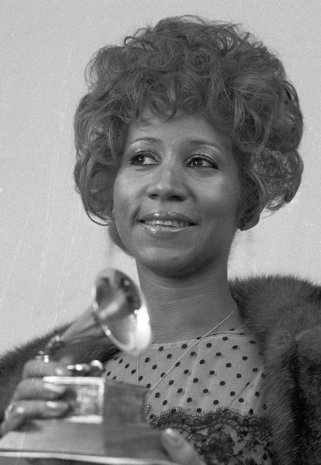 Queen of soul Aretha Franklin holds her Grammy Award for Best Rhythm and Blue performance of the song "Bridge Over Troubled Waters," March 13, 1972, in New York. (AP Photo/Dave Pickoff)
