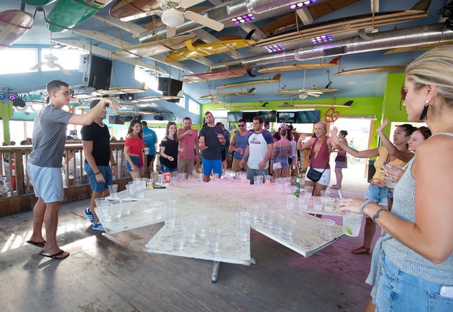 A Labor Day weekend crowd plays beer pong at northbeach in Dewey Beach.