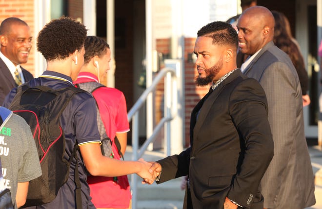 Tramaine Smith, founder of Born4Brothas, on Tuesday, helps greet students morning to McKean High School.