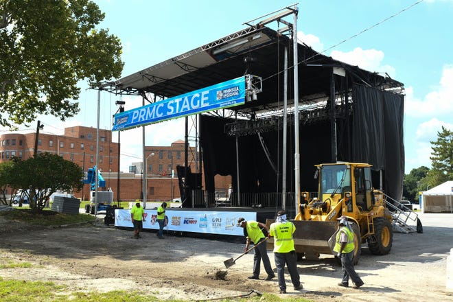 City workers help put final touches on the PRMC Stage area before the beginning of the National Folk Festival on Thursday, Sept 6, 2018.