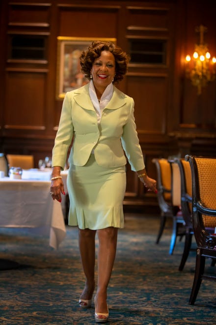 Sheila Marlowe wears a Tahari mint-green suit with fitted jacket, rosebud buttons and kick-pleats; white Calvin Klein blouse; and beige, sling-back patent leather Ellen Tracy pumps.