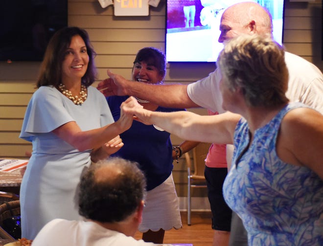 Candidate for state auditor Kathy McGuiness celebrated her victory in the Democratic primary at Grotto's Pizza in downtown Rehoboth Beach.