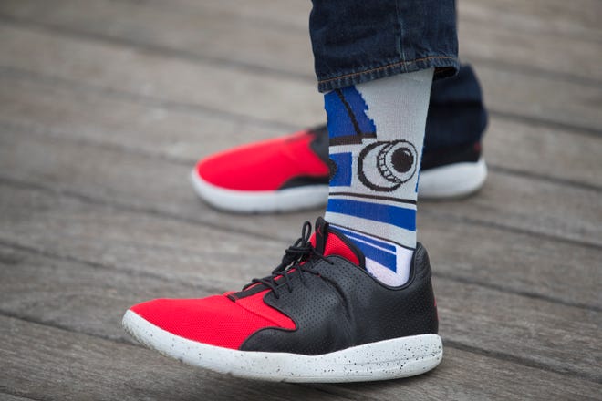 Tim Carr wears white and blue cotton R2D2 socks from Old Navy with red and black leather Nike Air Jordans and blue jeans.