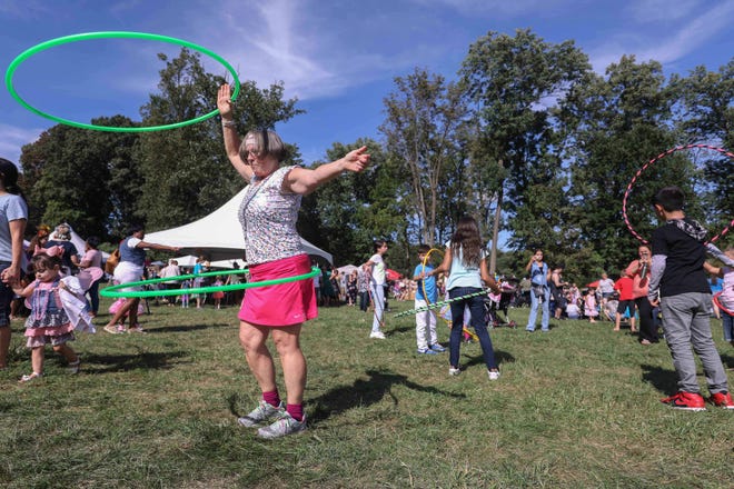Lois Long (left) hula hoops during the  Faerie Festival Sunday, Sept. 16, 2018, at Rockwood Park in Wilmington.