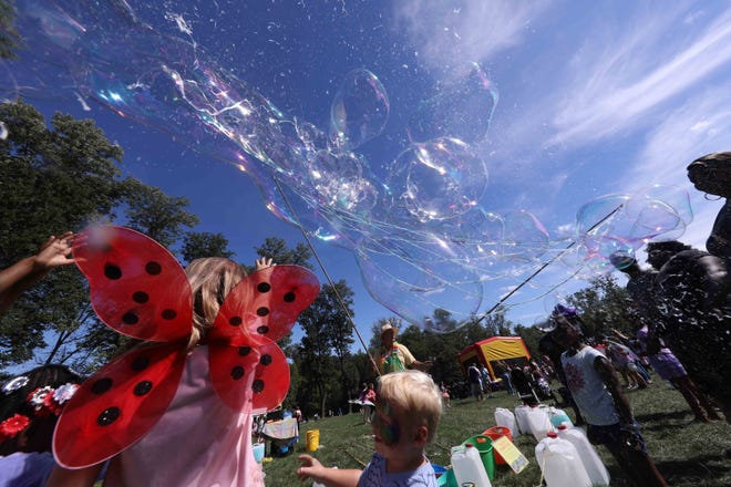 Bubbles fill the sky at the annual Faerie Festival Sunday at Rockwood Park in Wilmington.