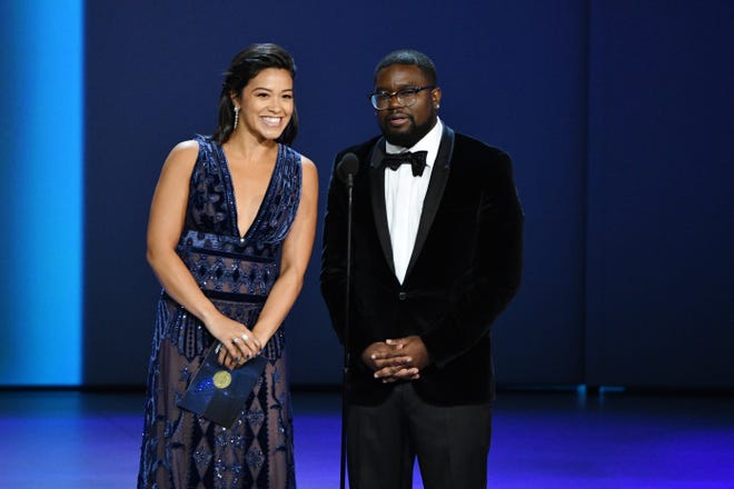 Gina Rodriguez, left, and Lil Rel Howery present the award for outstanding writing for a drama series.