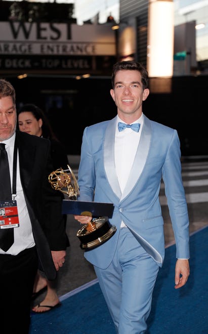 John Mulaney carries his Emmy for writing in a variety special for " John Mulaney: Kid Gorgeous at Radio City.