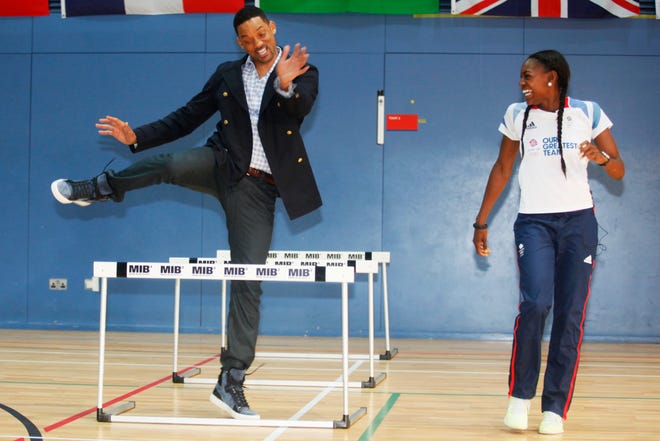 Will Smith tries the hurdles with Great Britain Olympic 400m hurdler Perri Shakes-Drayton at Ethos gym in London on May 16, 2012.
