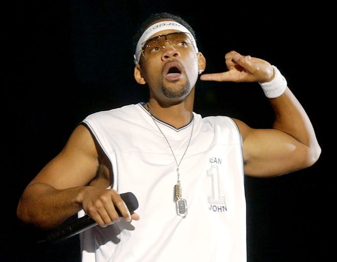 Will Smith listens for the crowd ' s response during his performance at the annual Wango Tango Music Festival at the Rose Bowl in Pasadena, Calif., on June 15, 2002.