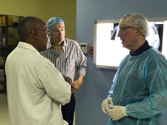 Nemours/A.I. duPont Hospital for Children surgeon Dr. Stephen Dunn, right, meets Dr. Colin Abel, chief surgeon at Bustamante Hospital for Children (left).