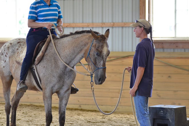 Iris works with trainer Marj Smith at Cedar Lane Equestrian Center.