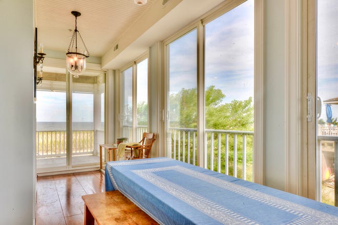 A screened porch at 1416 S. Bay Shore Drive at Broadkill Beach is spacious enough for large-scale dining.
