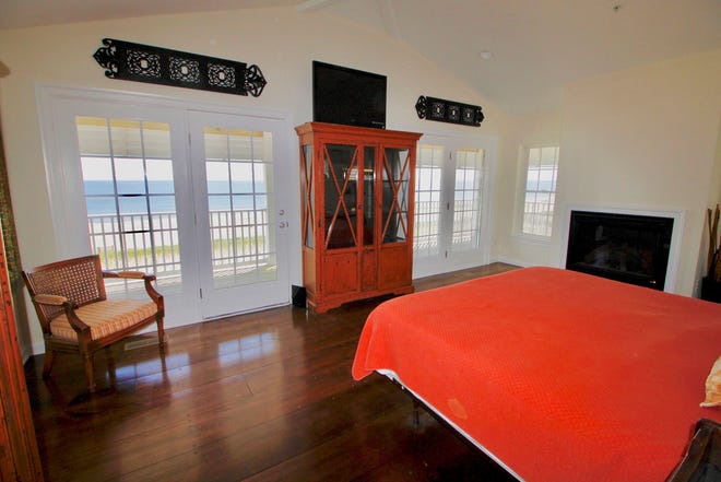 This bedroom at 1416 S. Bay Shore Drive  at Broadkill Beach has a gas fireplace and views of the bay.