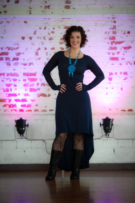 Sharin Macpherson wears a BCBG Max Azria navy blue high-low cotton dress; Leg Avenue tights from Trashy Diva; and Børn leather mid-calf boots.