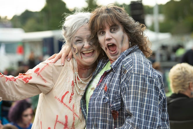 Fran Kiser, left, of Milton and Cindy Gray of Newark pose for a photo at Milton Zombie Fest.