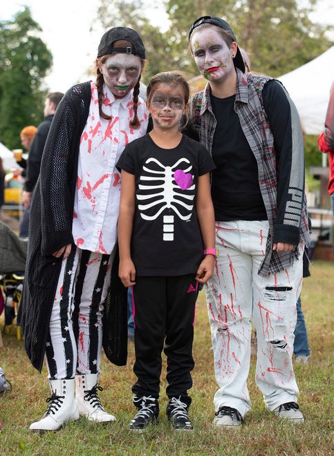 Candace Fortney, left, of Dover, Jerny Haines (10) of Milton and AJ Jackson of Dover pose for a photo at Milton Zombie Fest.