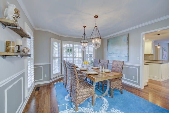 The formal dining room at 204 Lakeview Shores features decorative moldings.