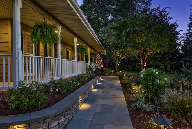 The house at 204 Lakeview Shores features a wrap-around porch, lighted stone walkways and newly redone driveway.