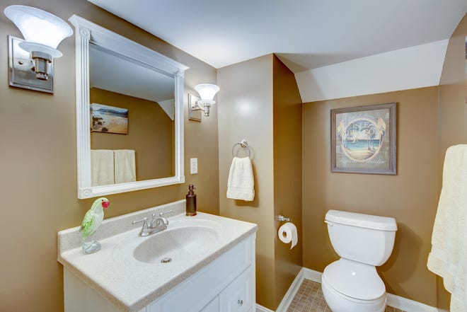 The house at 204 Lakeview Shores at Rehoboth Beach has four full bathrooms and two half baths.