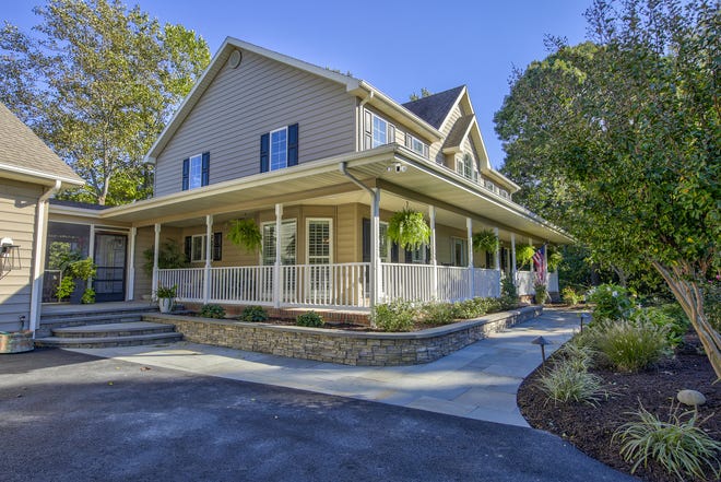 This 5,000-square-foot home at 204 Lakeview Shores in The Glade at  Rehoboth Beach features a front porch and landscaping.