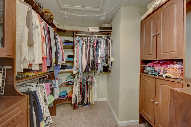 A custom walk-in closet at 204 Lakeview Shores in Rehoboth Beach offers specialized storage.