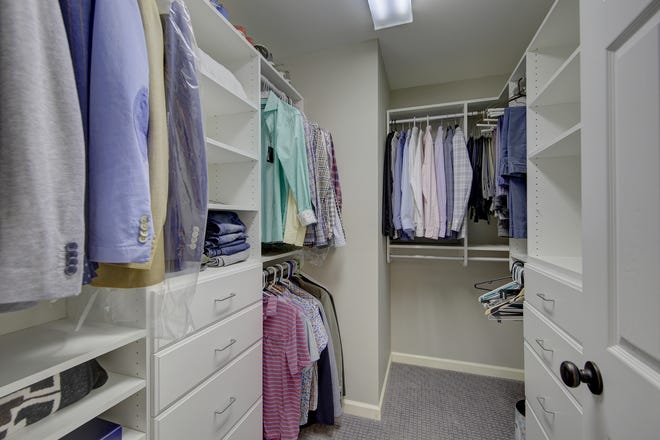 A custom walk-in closet at 204 Lakeview Shores offers specialized storage.
