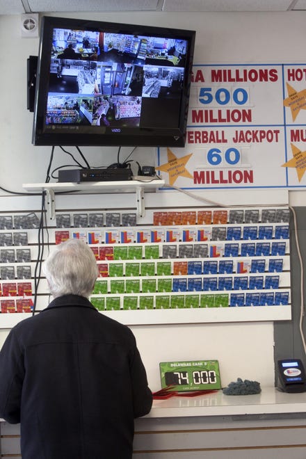 A customer fills out numbers Thursday, March 29, 2012, for the $540 million Mega Millions lottery at the Convenient Store on 9th and Orange Street in Wilmington, Delaware.
