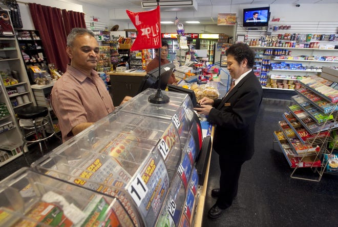 Sam Patel, owner of the Convenient Store on 9th and Orange Street punches in numbers for 19 Mega Million lottery tickets for Greg de Rio(cq), who was purchasing the tickets for his co-workers in the housekeeping department at the Hotel DuPont on Thursday, March 29, 2012.
