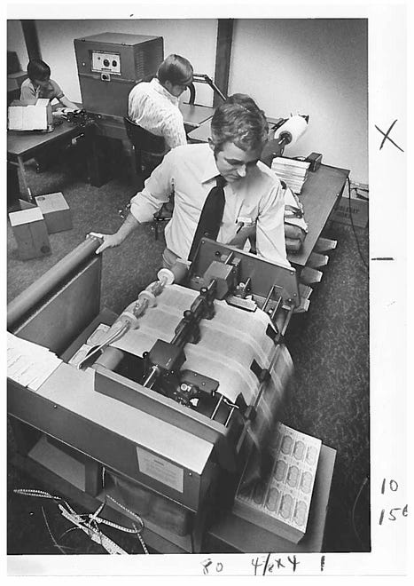 Lottery production supervisor John Lyons cuts tickets into single columns in 1976.