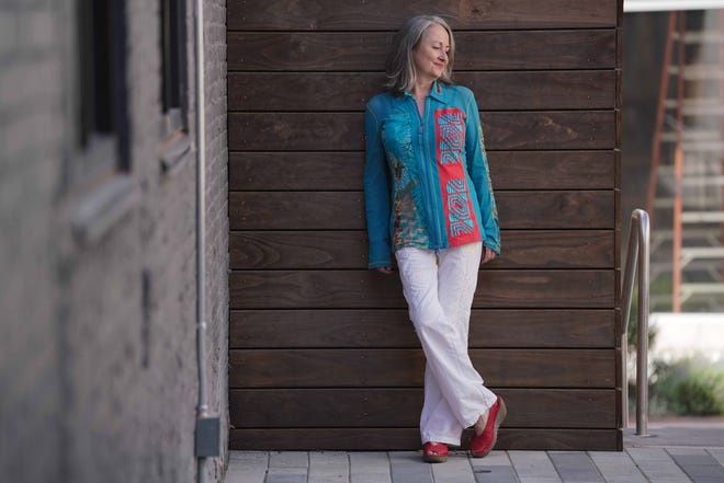 Lucy Clemens wears a turquoise blue net shirt with red from Save the Queen, made in Italy, with Fly of London beige, black and red shoes purchased through Amazon.