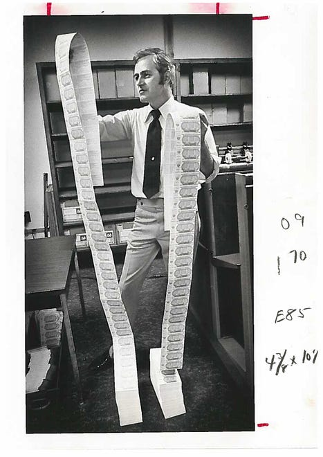 Production supervisor John Lyons checking lottery ticket numbers before they are sealed in plastic and sent to state banks in 1976.