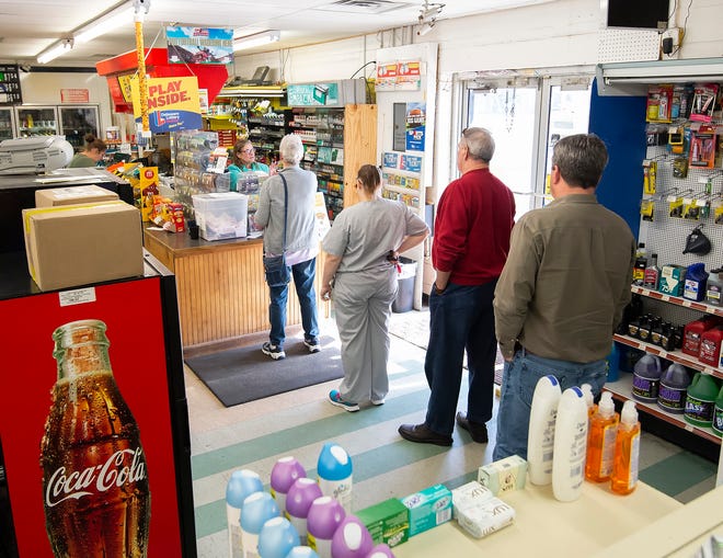 Customers wait in line to purchase Mega Millions lottery tickets at Bodie's Dairy Market in Millsboro.  Tuesday night's Mega Millions drawing is worth an estimated $1.6 Billion.