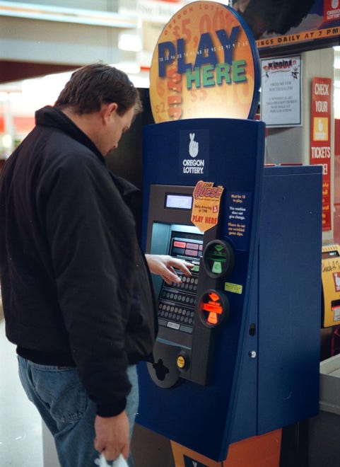 -

-Despite a $16 million jackpot, there was no line at the Fred Meyer South Megabucks Kiosk as David Nightengale buys a ticket for today's drawing.-

- Photo by Ron Cooper. #990256