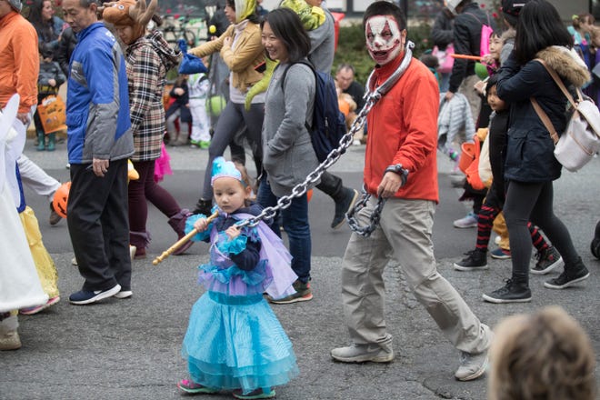 Parade goers enjoy the Newark Halloween Parade Sunday afternoon on Main Street in Newark.