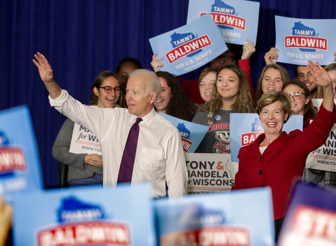Former Democratic Vice President Joe Biden and Tammy Baldwin wave during a rally with Wisconsin Democrats on the University of Wisconsin-Madison Campus, Tuesday Oct. 30, 2018, in Madison Wis. Biden called for more civility and dignity in politics during a rally, offering a sharp rebuke of President Donald Trump while telling the students they can "own" next week's election if they vote.  (Steve Apps/Wisconsin State Journal via AP)