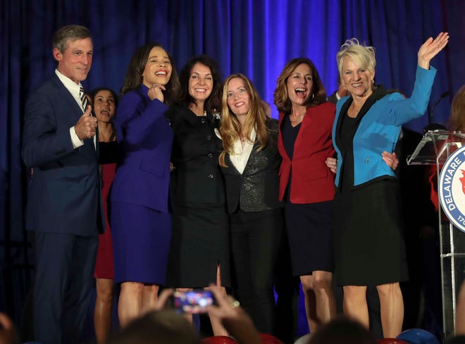 Gov. John Carney and Lt. Gov. Bethany Hall-Long flank statewide Democratic victors (second from left) Lisa Blunt Rochester (U.S. House), Kathy McGuiness (state auditor), Colleen Davis (state treasurer) and Kathy Jennings (state attorney general) at the DoubleTree Hotel in Wilmington Tuesday.