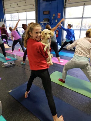 A dog finds a new friend at Doggy Noses & Yoga Poses's visit to Iris Mind+Body in Cedar Grove, New Jersey earlier this month.