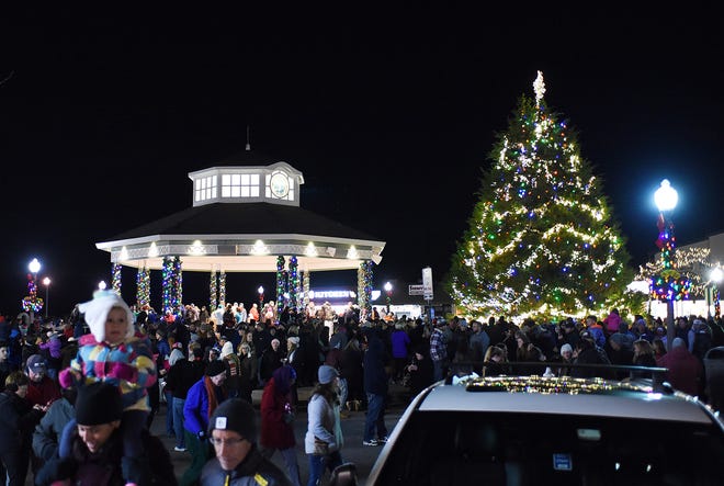 Under a full moon, several thousand visitors came out in the cold to sing Christmas carols and light Rehoboth Beach's Christmas tree on Friday night in downtown Rehoboth Beach. Clear Space Theater provided the musical selections as the tree donated by Pat and Paul Romaine was decorated with hundreds of lights.