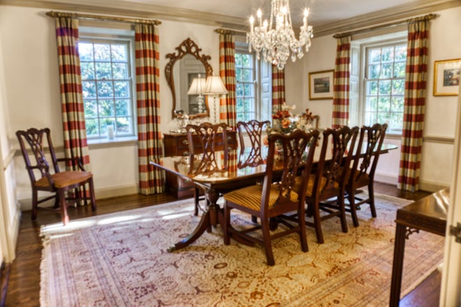 A formal dining room at 2 Alapocas Drive features millwork and a built-in china closet.